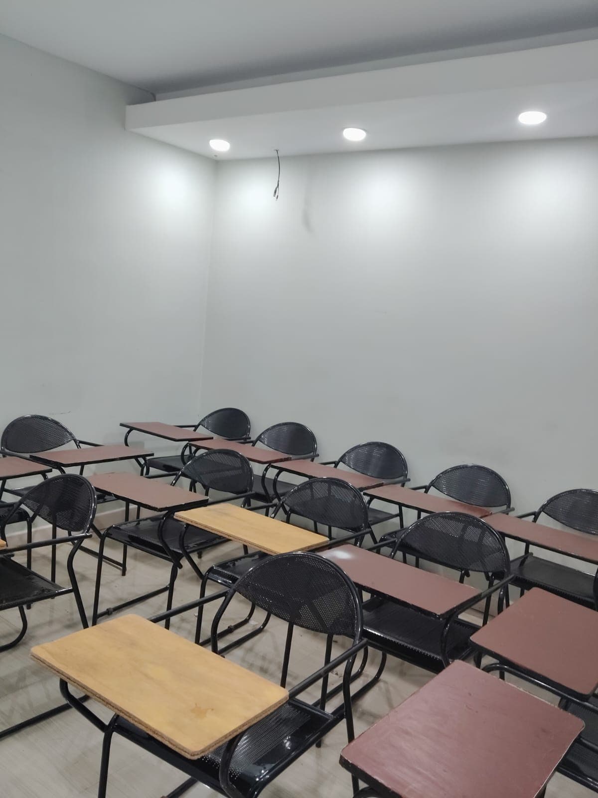 Group of diverse happy students studying in a modern bright classroom