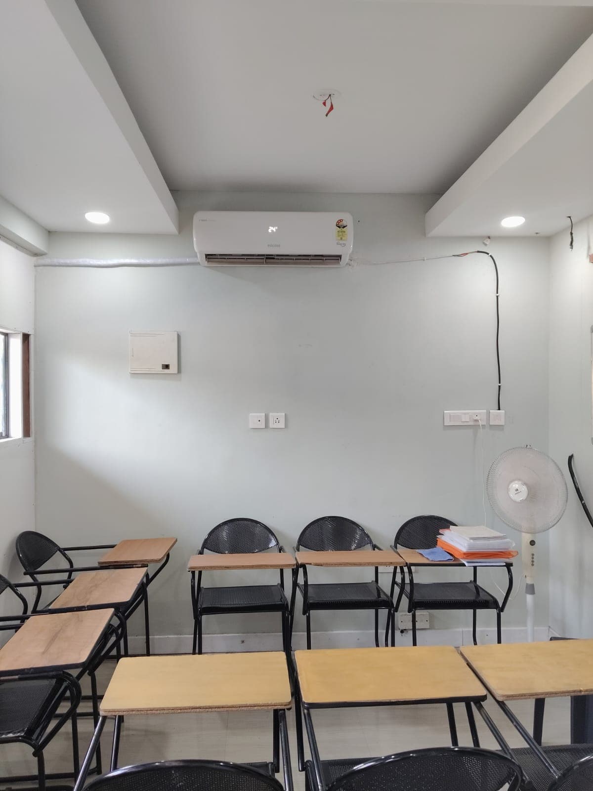 Group of diverse happy students studying in a modern bright classroom